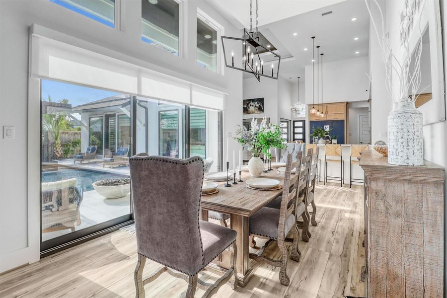 Accordion doors open up to the pool from the dining area, offering guests additional space to gather, eat, and play.