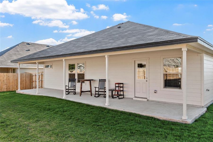 Back of property featuring a patio area and a shingled roof