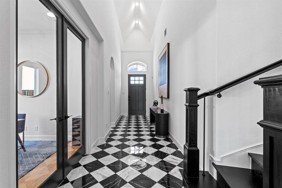 Entryway featuring stairway and high vaulted ceiling Entryway featuring stairway and high vaulted ceiling