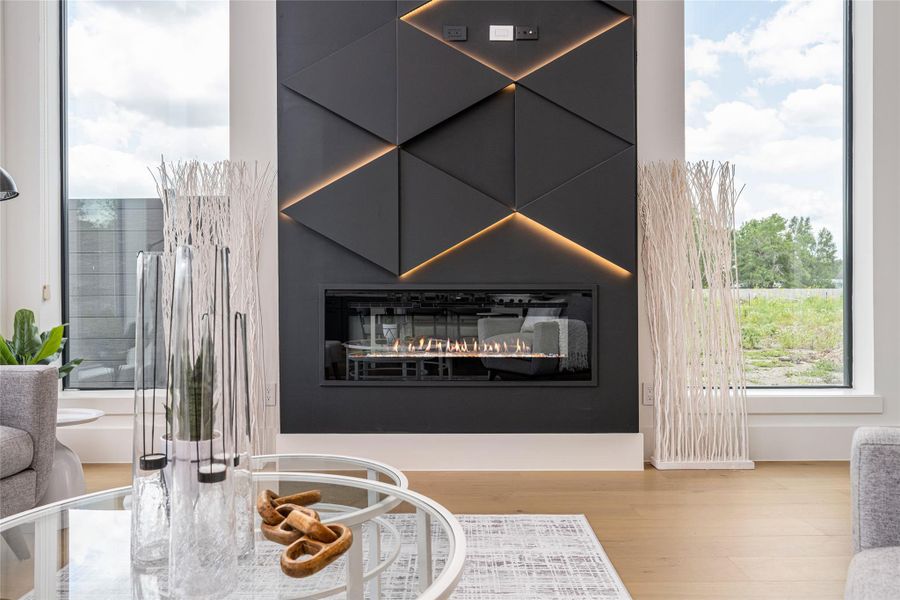 A sleek electric fireplace wrapped in an LED-lit feature wall creates an eye-catching focal point and elevates the living experience A sleek electric fireplace wrapped in an LED-lit feature wall creates an eye-catching focal point and elevates the living experience