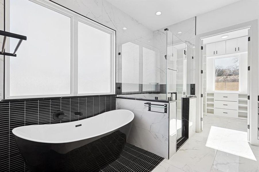 Bathroom featuring plus walk in shower and tile walls