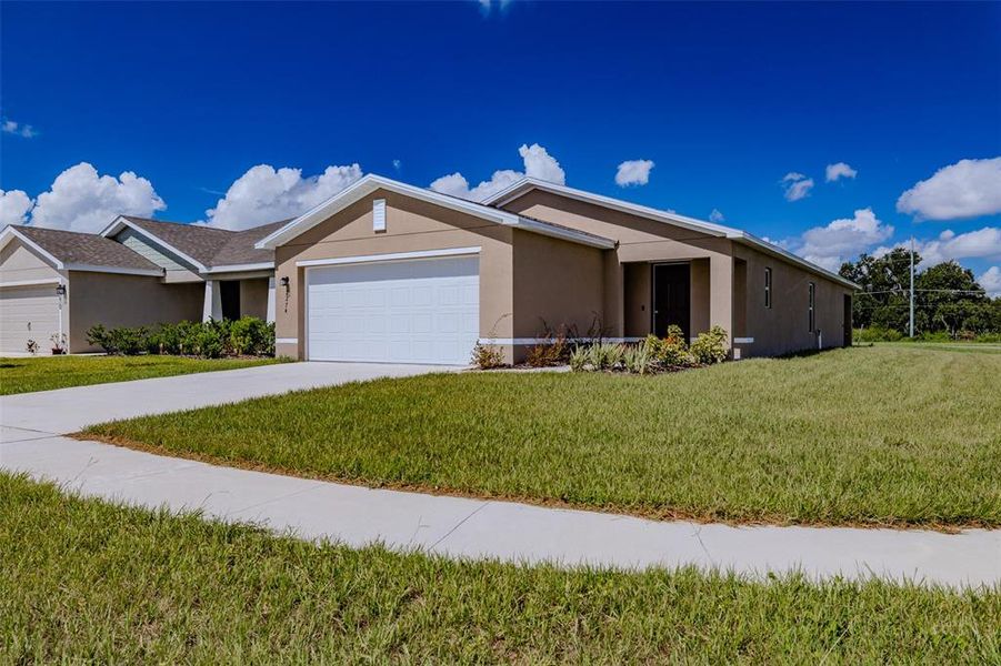 Front exterior of a new home in , Eagle Lake, FL, highlighting curb appeal (Image 21).