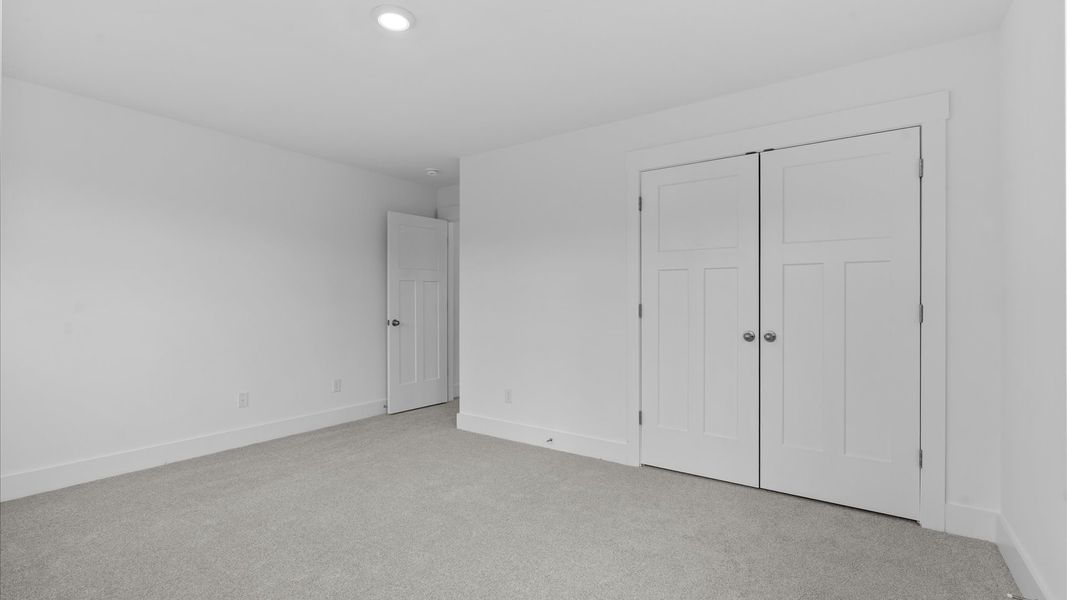 First-rate secondary bedroom with a spacious walk-in closet and elegant carpeted flooring located at Pleasant Falls
