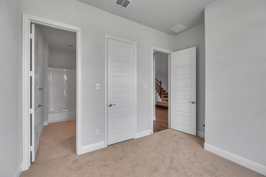 Unfurnished bedroom featuring light colored carpet