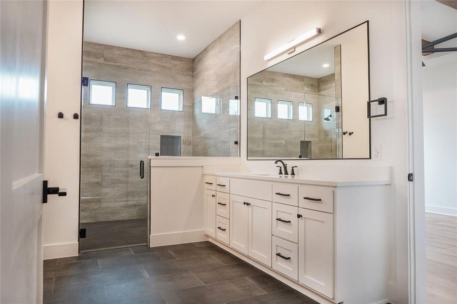 Bathroom with a shower with door and vanity