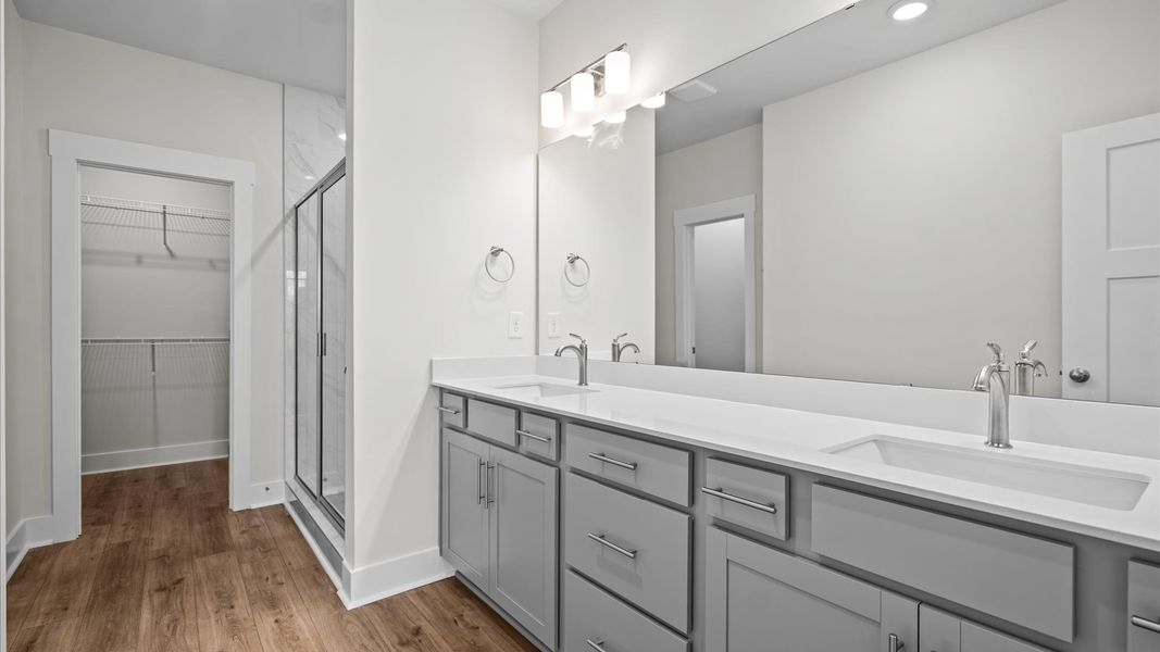Spacious and modern primary bathroom with tiled walk-in shower and first-class double vanity at Silo Ridge in Anderson, SC