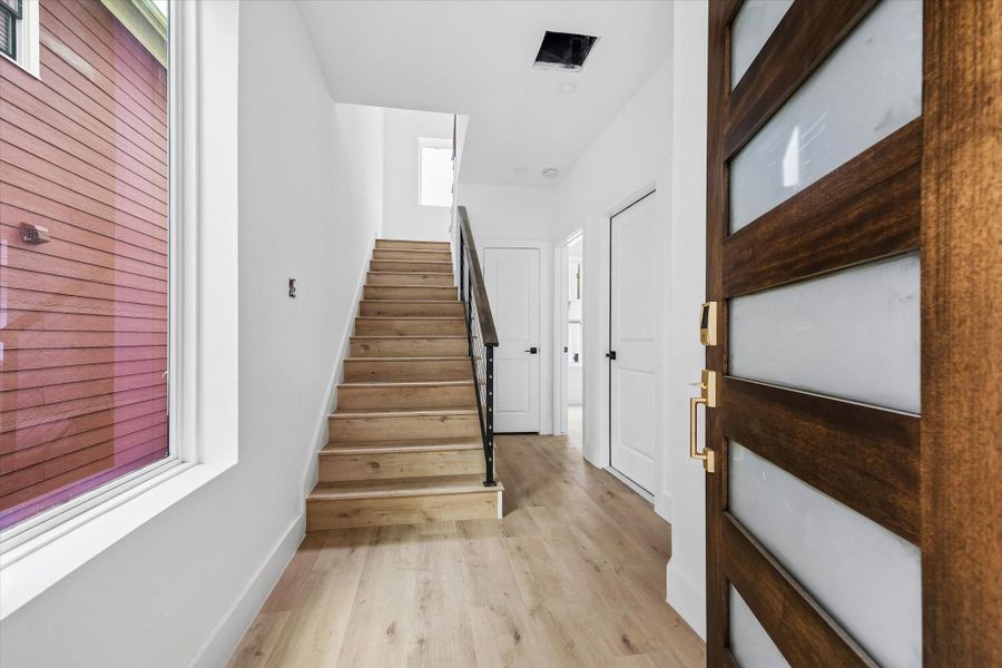 Upon entering, you’re greeted by wood-look LVP flooring, tall ceilings, and a light, airy feel throughout.