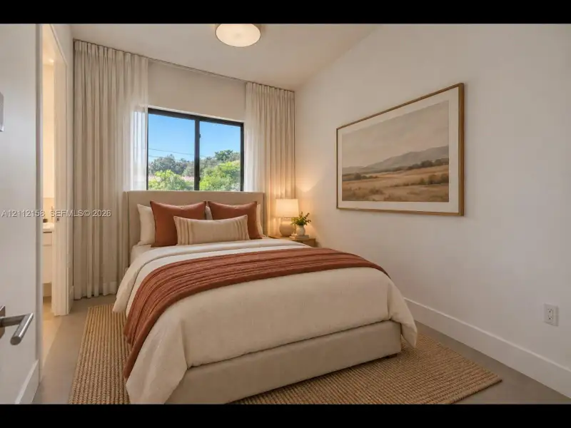 Serene bedroom with a large black-framed window, floor-to-ceiling drapery, and calming neutral tones