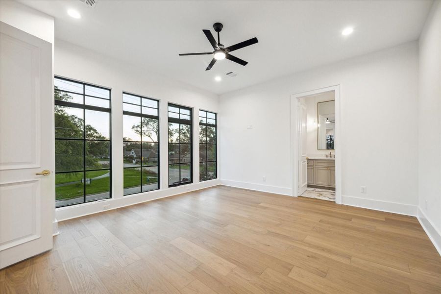 One of three large secondary bedrooms upstairs - check out the gorgeous windows!  This bedroom will have amazing park views!*Picture is of a recently constructed home by the builder.  1519 Candlelight will be similar in quality, but these pictures are not meant to be an exact representation of the new home. Specs of home may change at sole discretion of the seller.