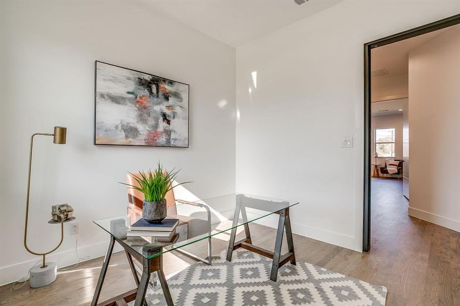 Office space with wood finished floors and baseboards Office space with wood finished floors and baseboards