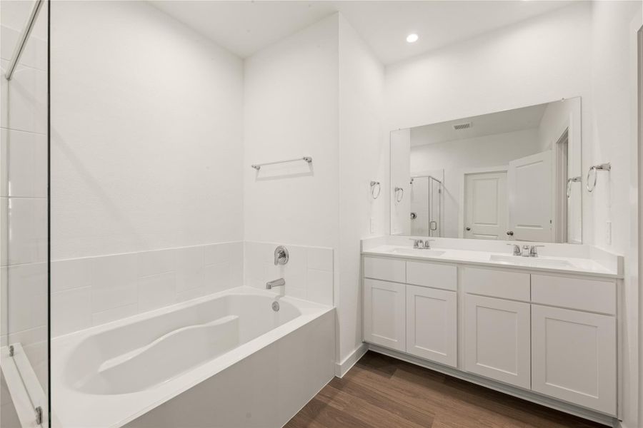 This meticulously designed bathroom featuring a generous double vanity with dual sinks - plenty of space to spread out and to share.