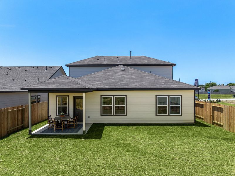 A house with a fence and a lawn in front of it. A house with a fence and a lawn in front of it.