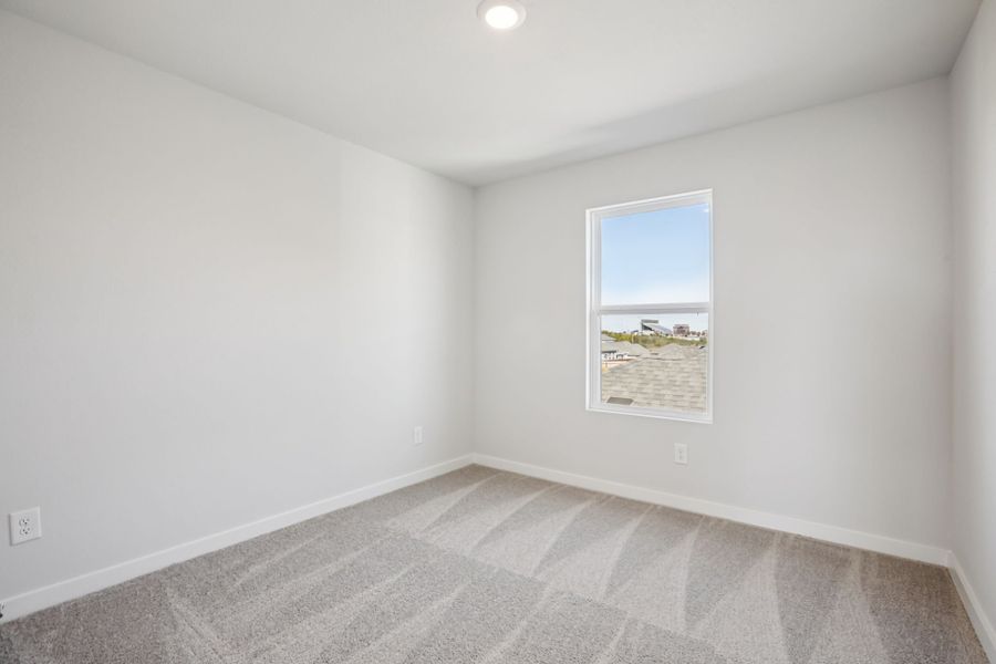 A room with a white wall and a window.