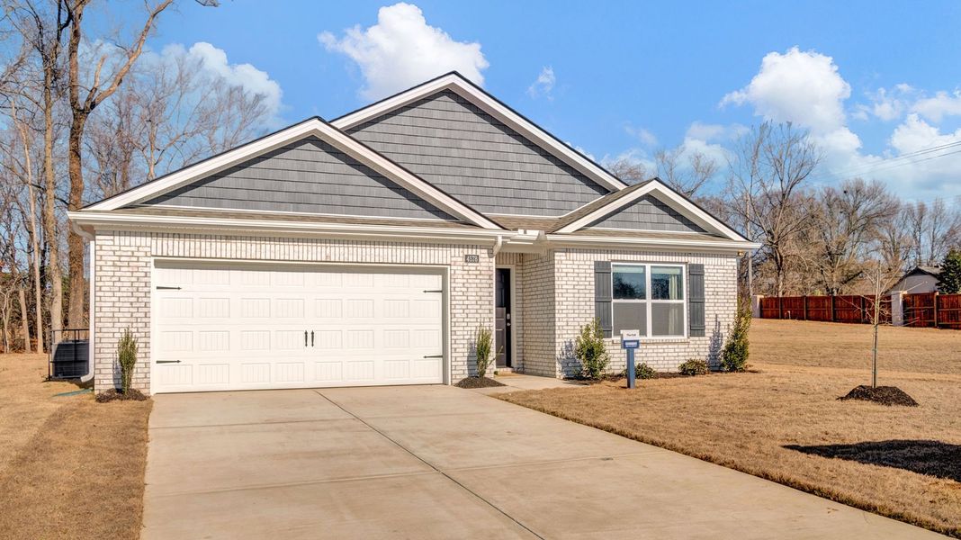 Front exterior of a new home in Riggs Pointe, Millington, TN, highlighting curb appeal (Image 2).