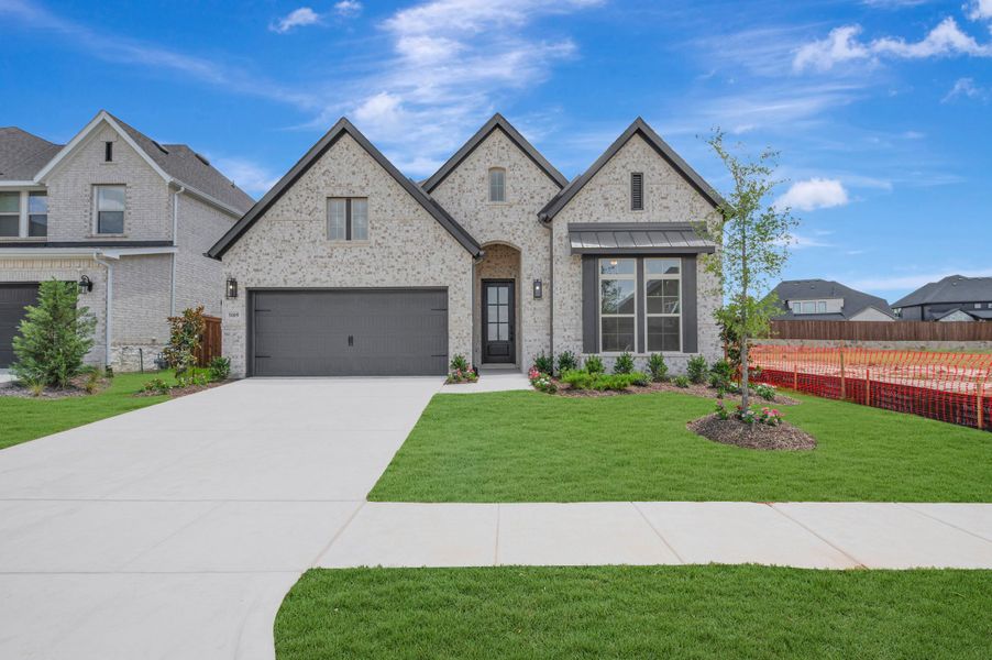 Front exterior of a new home in Sandbrock Ranch, Aubrey, TX, highlighting curb appeal (Image 1). Front exterior of a new home in Sandbrock Ranch, Aubrey, TX, highlighting curb appeal (Image 1).
