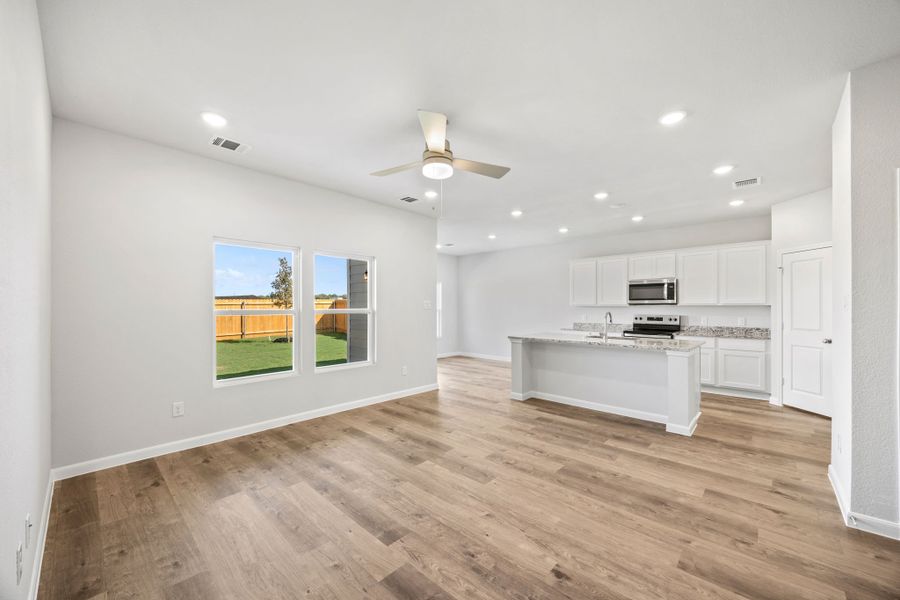 A kitchen with white cabinets.