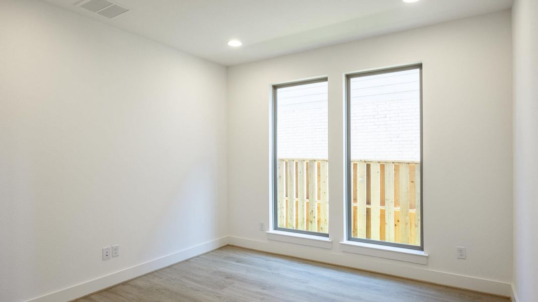 Unfurnished room featuring light wood-style flooring and recessed lighting Unfurnished room featuring light wood-style flooring and recessed lighting