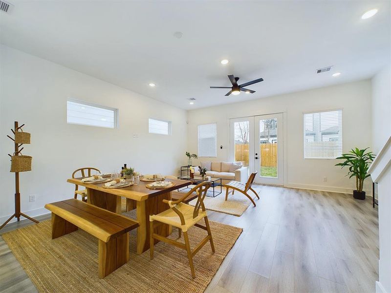 open concept living/dining/kitchen area on the first floor including Bifold Doors to walk out into backyard.