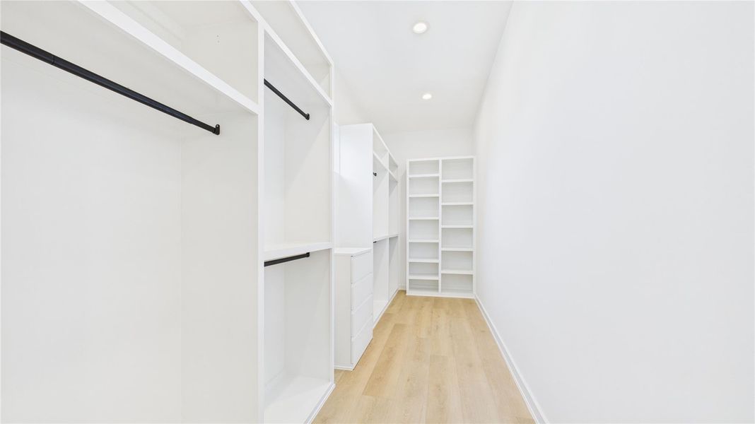Primary lux closet with built in shelving