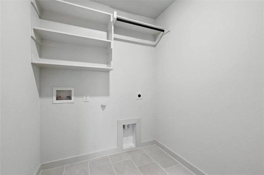 Laundry area with gas dryer hookup, hookup for a washing machine, and hookup for an electric dryer Laundry area with gas dryer hookup, hookup for a washing machine, and hookup for an electric dryer