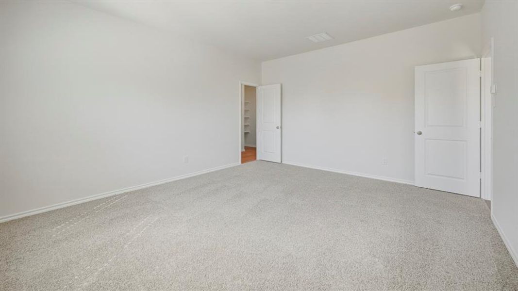 Carpeted spare room with baseboards