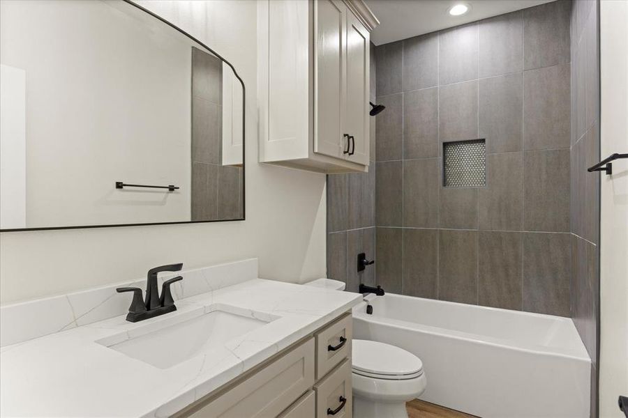 Full bath featuring shower / tub combination, vanity, and recessed lighting