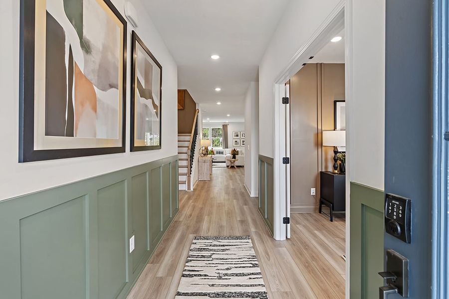 A long hallway with a wood floor.