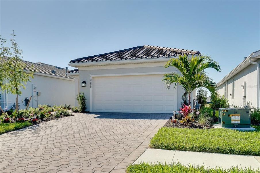 Front exterior of a new home in BeachWalk by Manasota Key, Englewood, FL, highlighting curb appeal (Image 27).