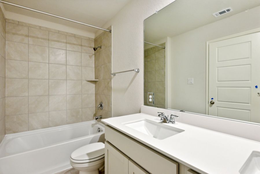 Guest bedroom in the Red River floorplan at a Meritage Homes community.