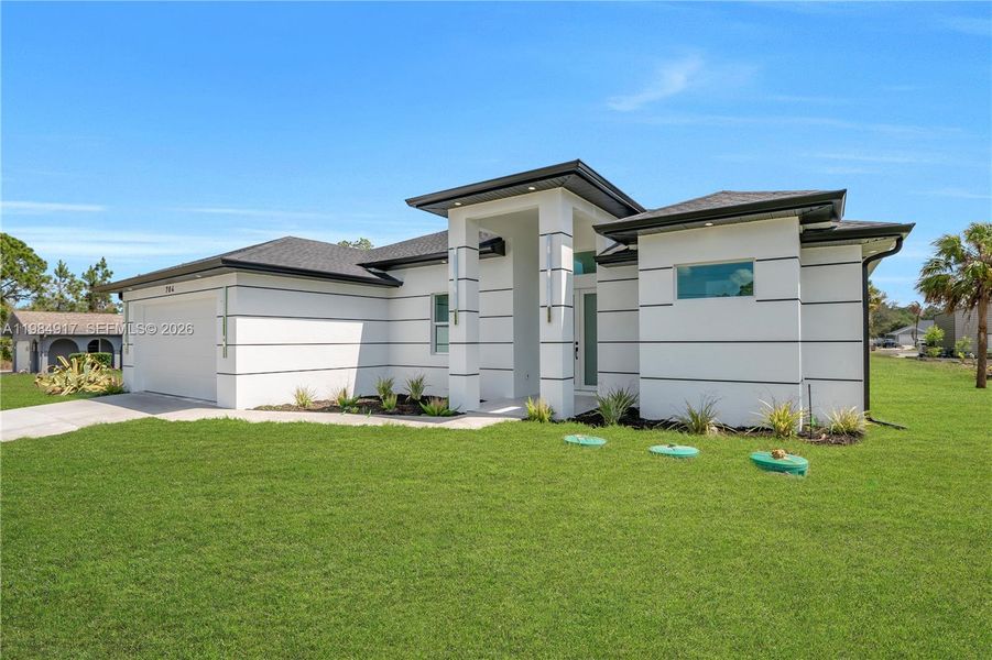 Front exterior of a new home in , Lehigh Acres, FL, highlighting curb appeal (Image 29). Front exterior of a new home in , Lehigh Acres, FL, highlighting curb appeal (Image 29).