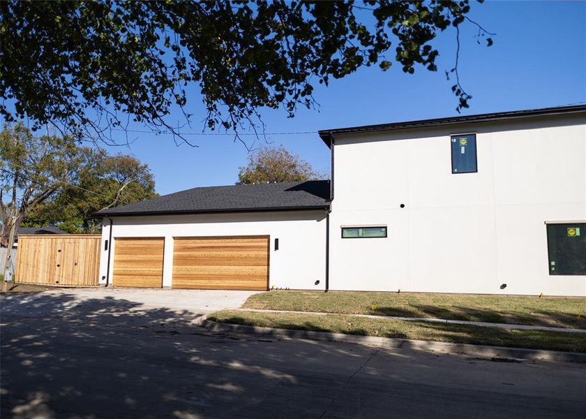 View of home's exterior featuring a lawn and a garage