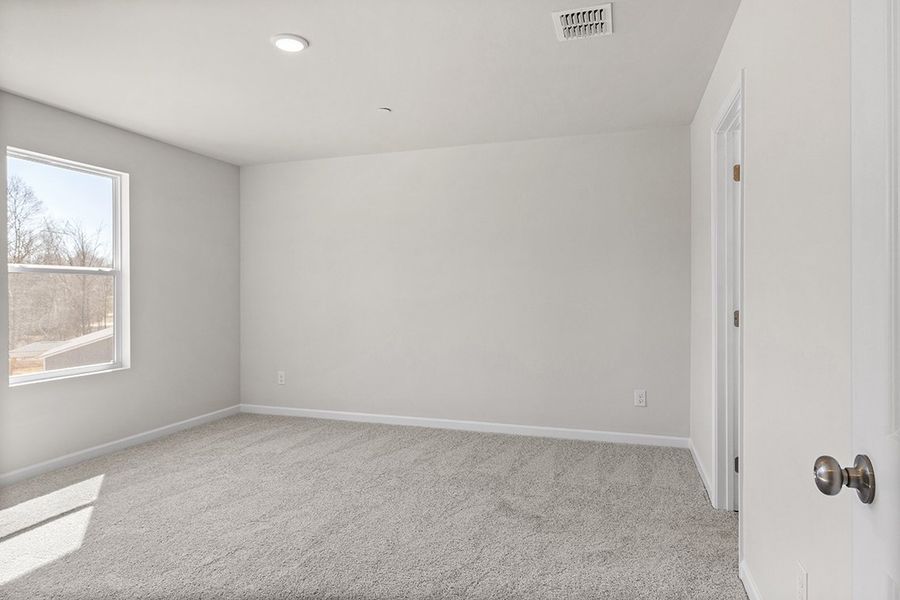 A room with a carpet and a window. A room with a carpet and a window.