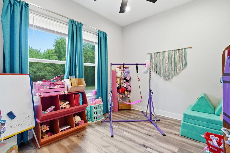 Secondary bedroom with high ceiling, ceiling fan and windows overlooking front yard. Secondary bedroom with high ceiling, ceiling fan and windows overlooking front yard.