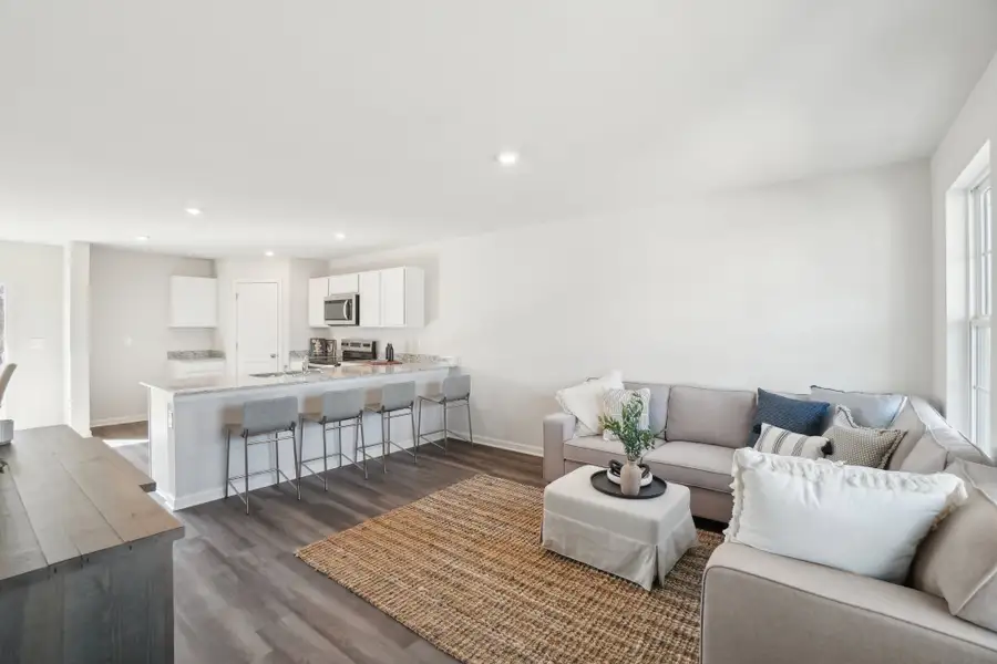 A living room with a dining table and couches.