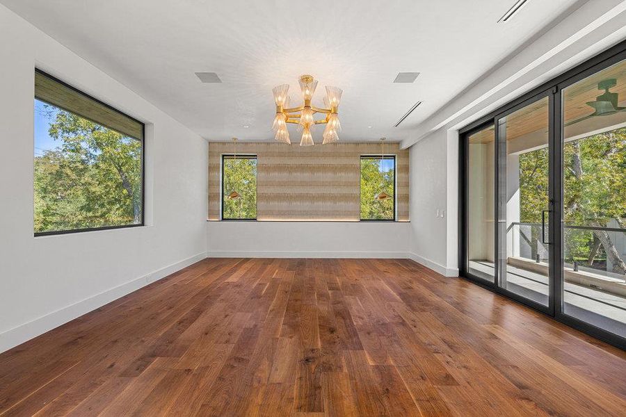 Unfurnished room with a chandelier and dark wood-type flooring