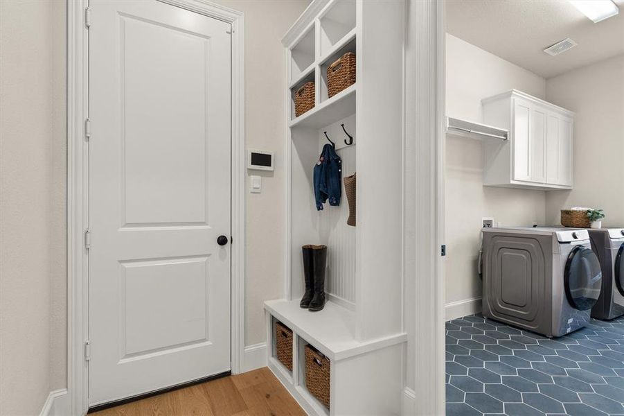 Laundry next to the mud room and connects to the primary closet for easy access.