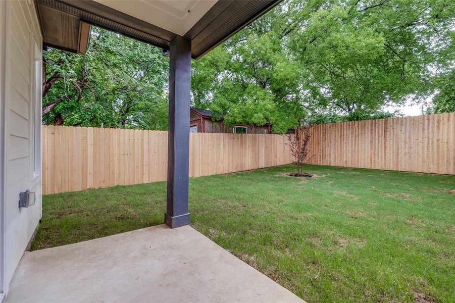 View of yard with a covered patio and a fenced backyard