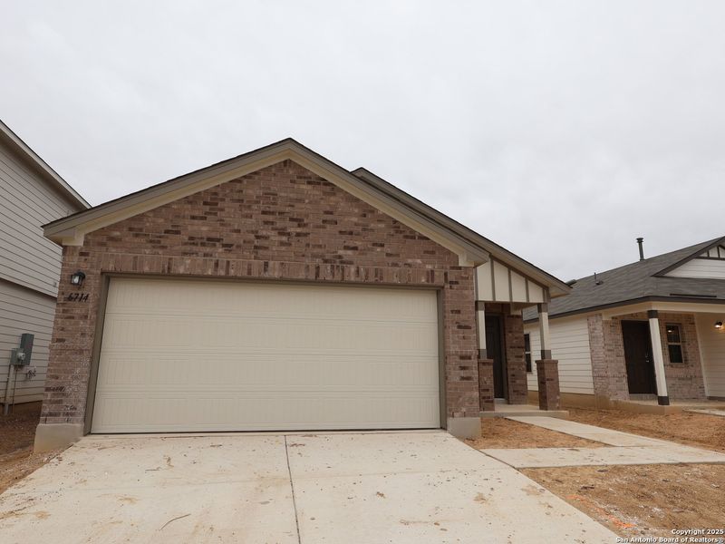 Front exterior of a new home in Winding Brook, San Antonio, TX, highlighting curb appeal (Image 23).