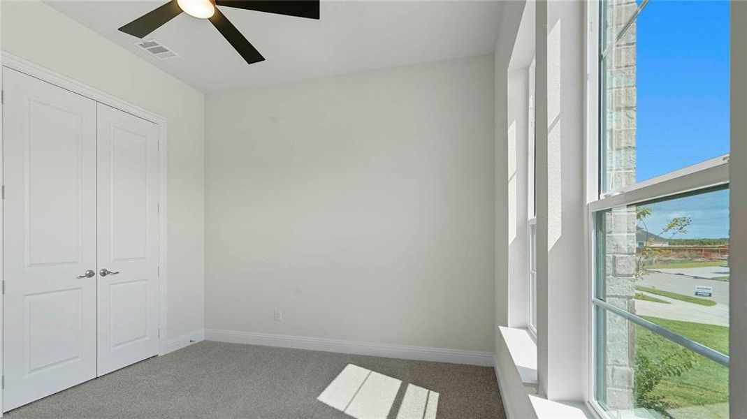 Room featuring light-colored walls, grey carpeting, and white trim
