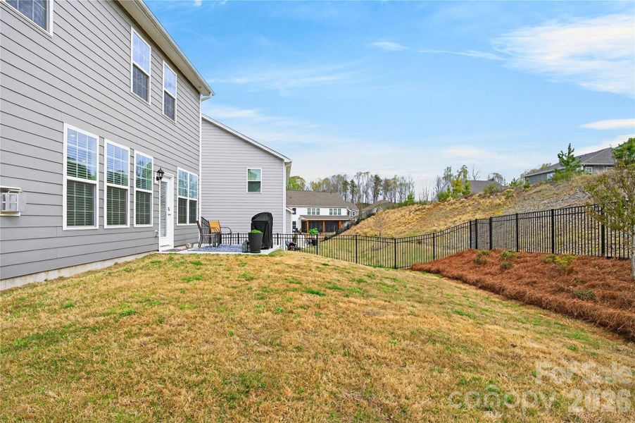 The owners installed an aluminum fence and landscaping along the back fence line.