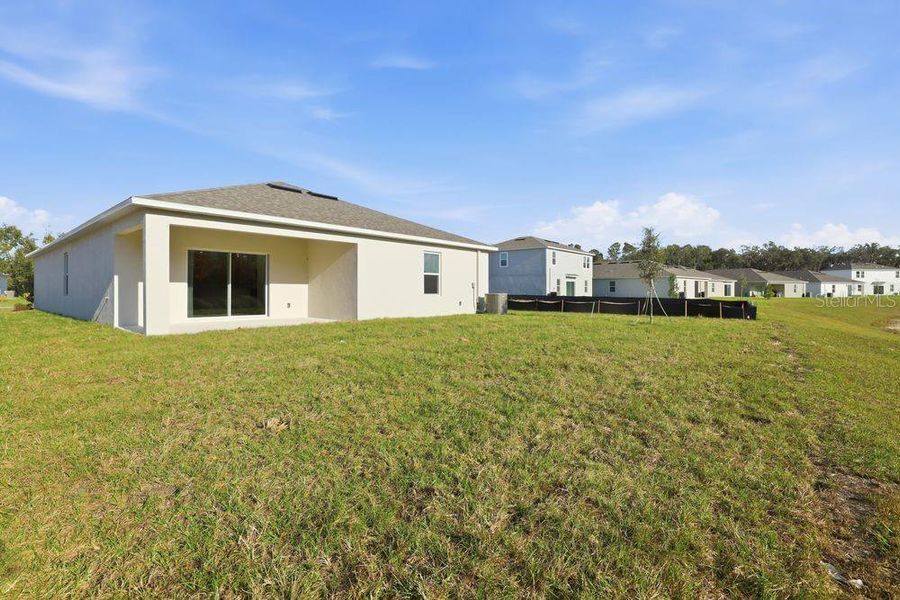 Exterior details and patio area of a home in Palm Wind, Hudson (Image 21).