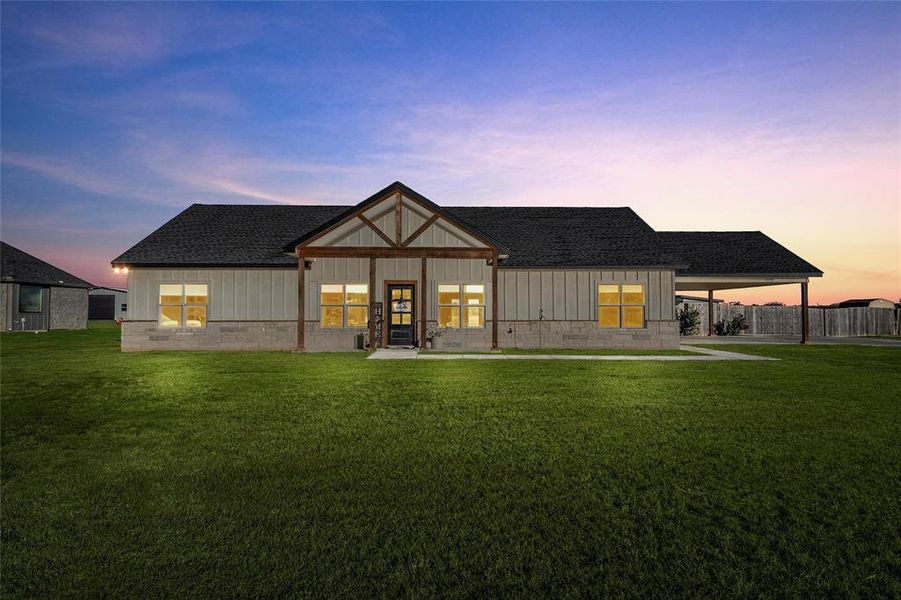 Rear view of property featuring a porch, a shingled roof, and board and batten siding