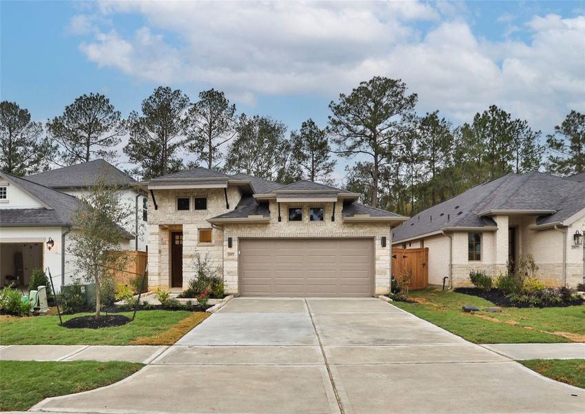 Front exterior of a new home in Woodhavyn 40', Magnolia, TX, highlighting curb appeal (Image 1). Front exterior of a new home in Woodhavyn 40', Magnolia, TX, highlighting curb appeal (Image 1).