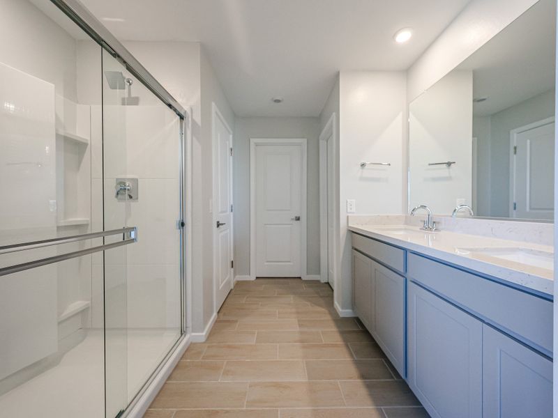 A bathroom with a glass shower. A bathroom with a glass shower.