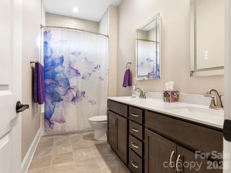 1st Flr, Full bath, tiled to celling, illuminated mirrors; dual vanity; tile floor
