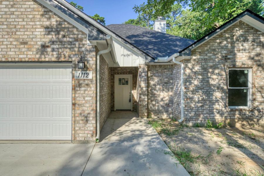 Front exterior of a new home in , Huntsville, TX, highlighting curb appeal (Image 2). Front exterior of a new home in , Huntsville, TX, highlighting curb appeal (Image 2).