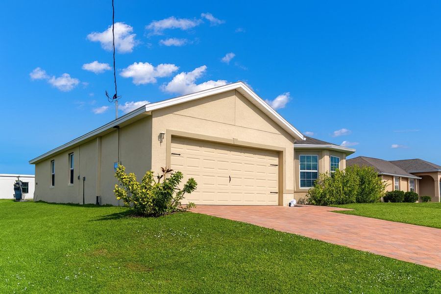 Front exterior of a new home in , Cape Coral, FL, highlighting curb appeal (Image 14). Front exterior of a new home in , Cape Coral, FL, highlighting curb appeal (Image 14).