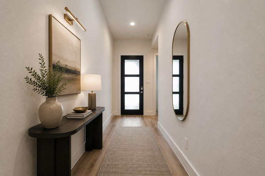 A long, welcoming entry sets the tone with warm wood-look flooring, clean modern finishes and an 8-foot glass-paneled front door that draws in natural light. *virtually staged*