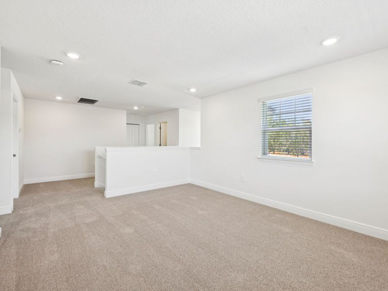 Spacious, unfurnished interior of a new home in The Reserve at Hammock Oaks - Signature Series, Lady Lake (Image 11).