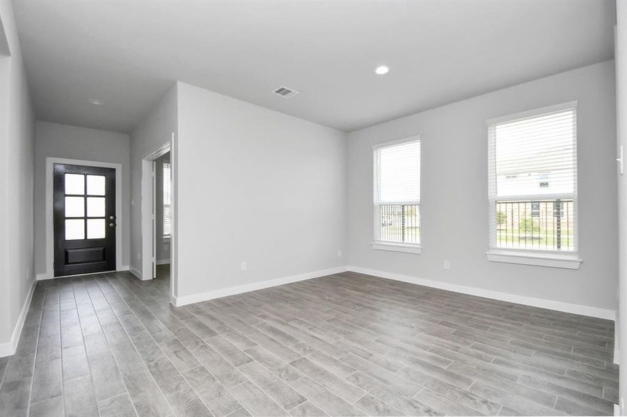 Craft enduring memories with loved ones around the table in this roomy dining area. It boasts stylish flooring, personalized paint, and is conveniently situated next to the family room and kitchen, fostering an open and inclusive ambiance. Sample photo of completed home with similar floor plan. Actual colors and selections may vary.